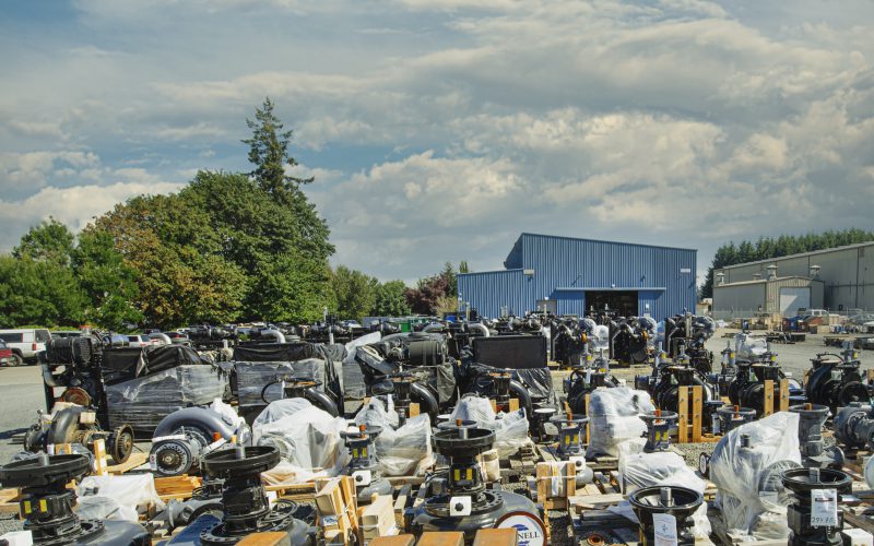 Wrapped pump ends, engines, and components staged in the equipment yard