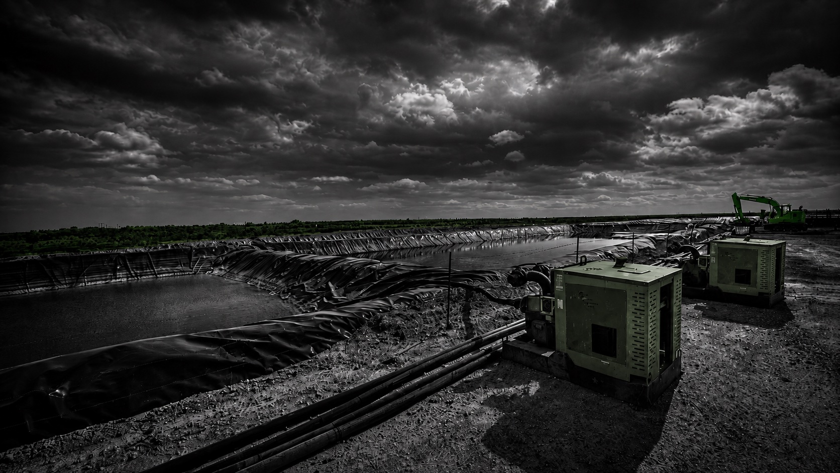 Two Patriot pump units dewatering a lined retention pond at a Midland site with an excavator in the background